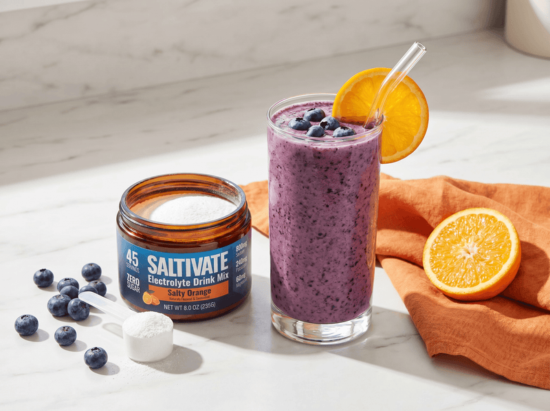 Blueberry orange smoothie with fresh blueberries and an open jar of Saltivate Orange