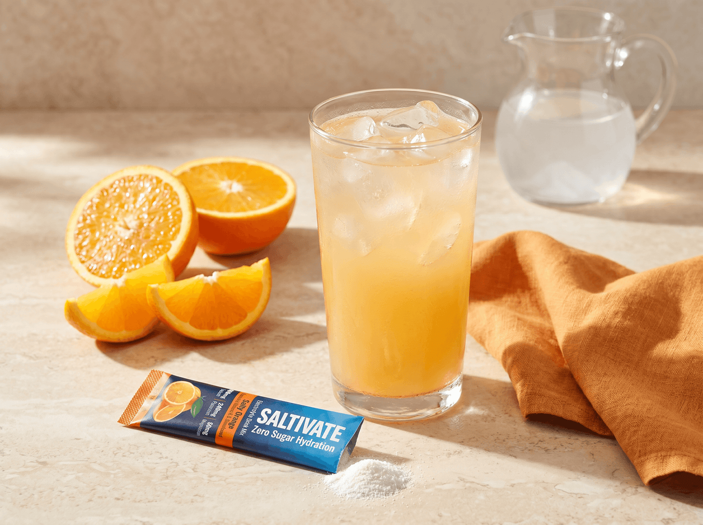 Orange adrenal cocktail over ice with a Saltivate Orange stick packet beside the glass