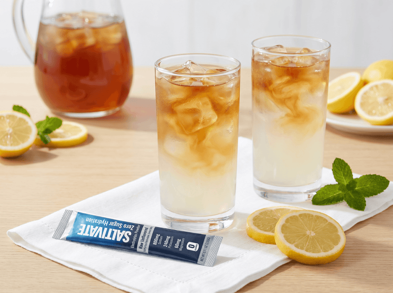 Two glasses of salty palmer iced tea lemonade with a Saltivate stick packet on a napkin