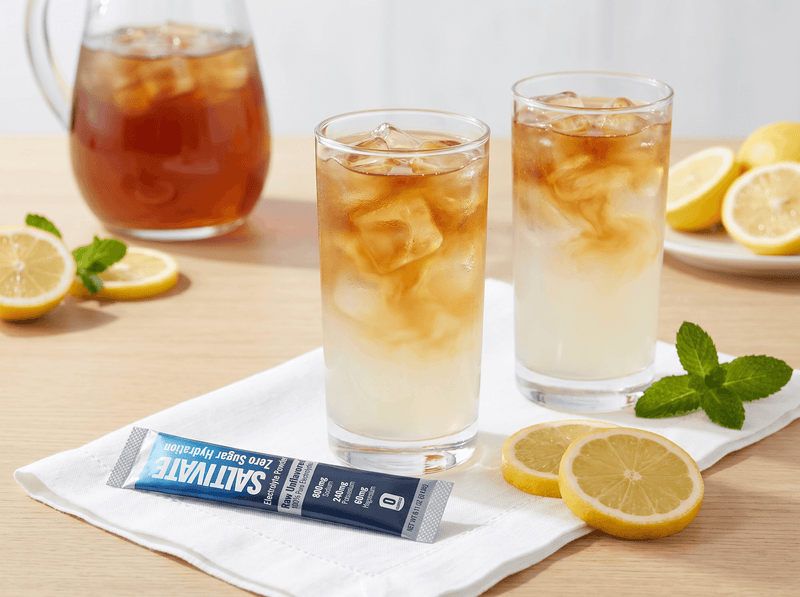 Two glasses of salty palmer iced tea lemonade with a Saltivate stick packet on a napkin
