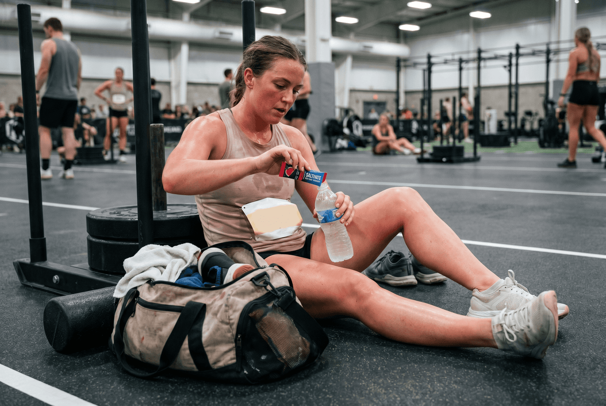 Athlete mixing Saltivate electrolytes between stations at a fitness race