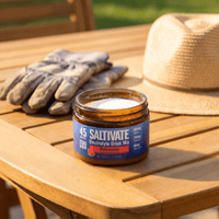 Saltivate Watermelon 45-serving jar open on a patio table beside work gloves and a sun hat
