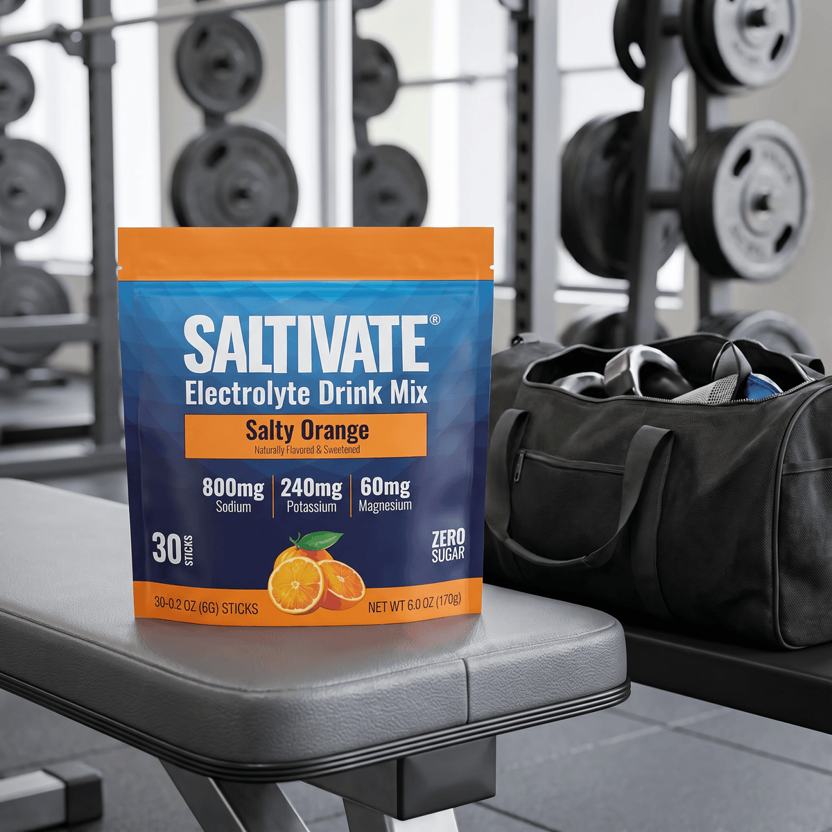 Saltivate Salty Orange 30-count stick pack pouch on a gym bench beside a duffel bag