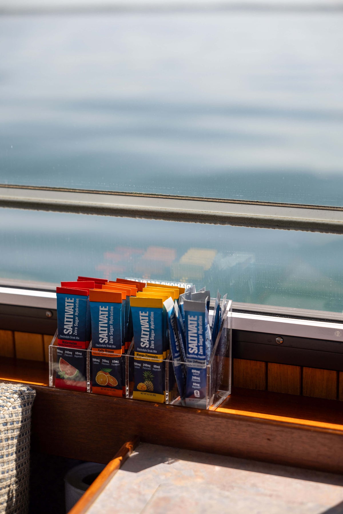 Acrylic organizer loaded with four flavors, ocean view behind