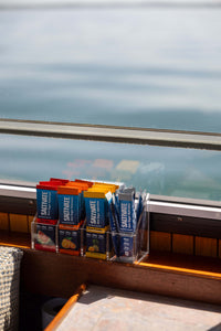 Acrylic organizer loaded with four flavors, ocean view behind