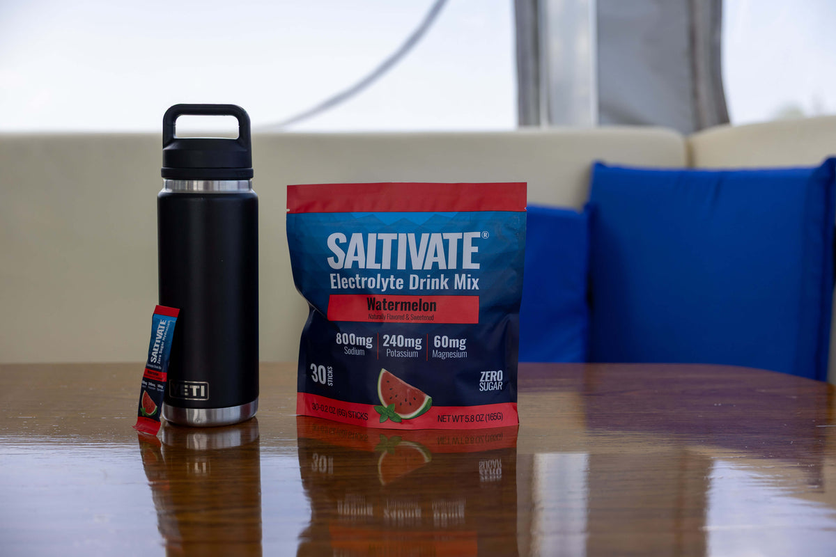 Watermelon 30-stick pouch next to a water bottle on a boat table