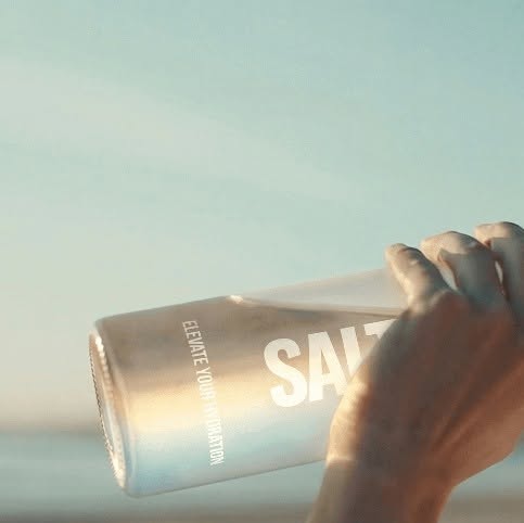 Drinking Saltivate on the beach at golden hour