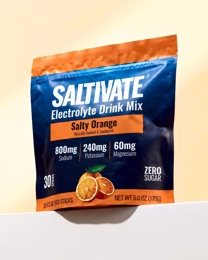 Saltivate Salty Orange 30-stick pouch on a white ledge against a pale peach backdrop