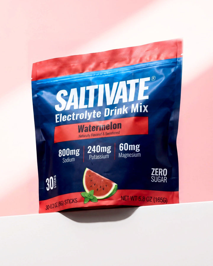 Saltivate Watermelon 30-stick pouch on a white ledge against a pale pink backdrop