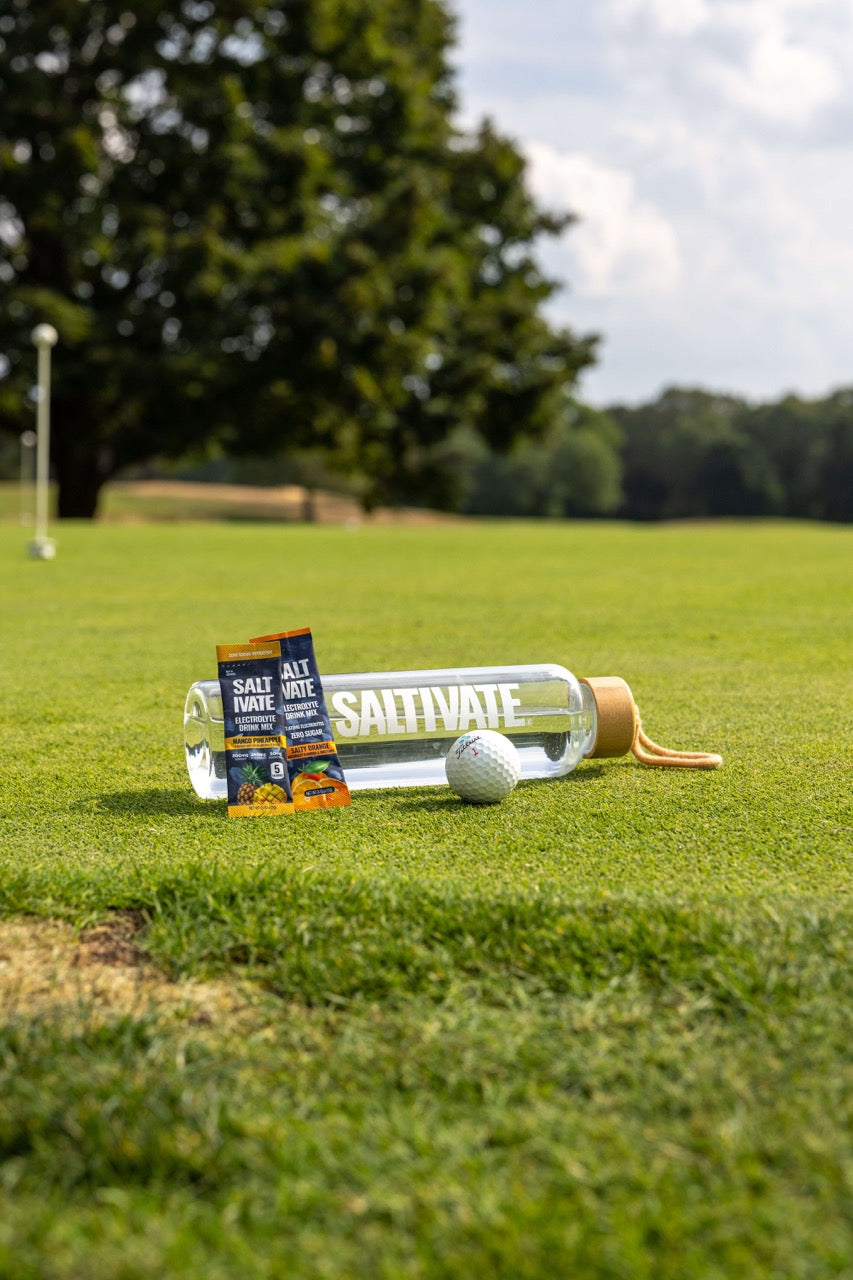 Saltivate bottle and stick pack on a golf green