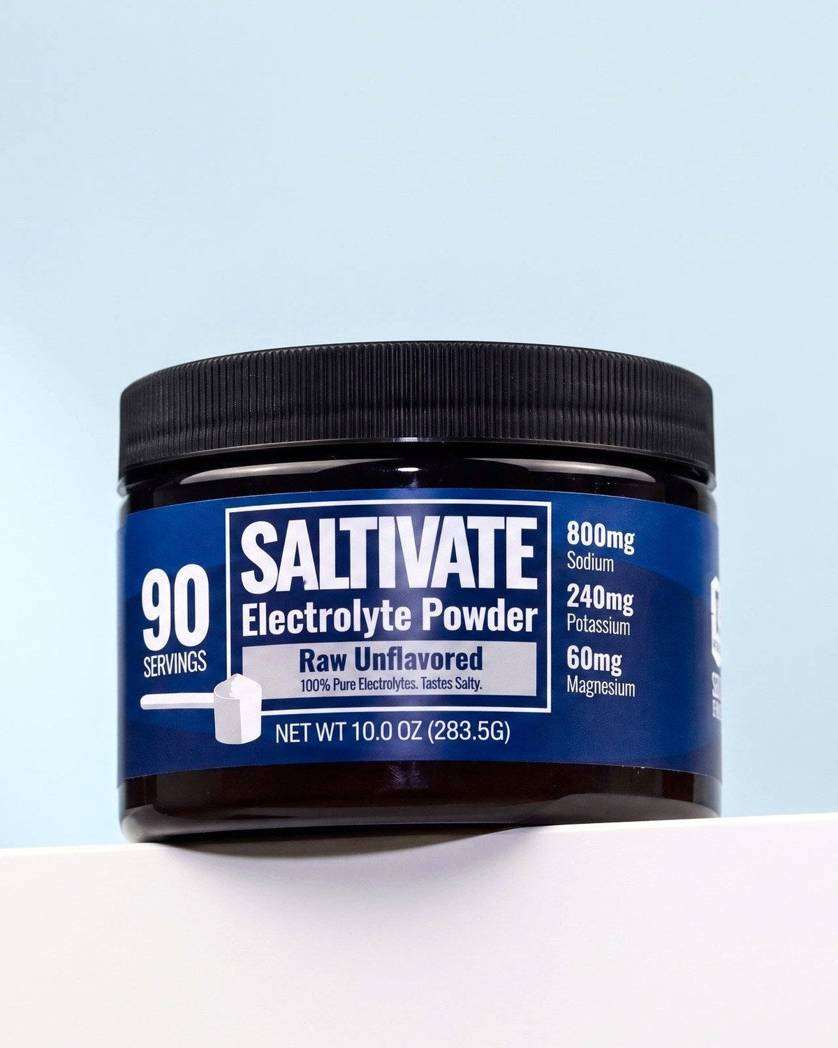 Saltivate Raw Unflavored jar on a white ledge against a pale blue-grey backdrop