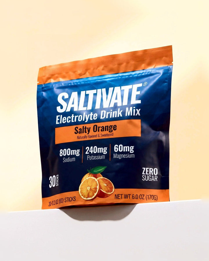 Saltivate Salty Orange 30-stick pouch on a white ledge against a pale peach backdrop