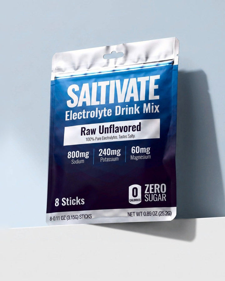 Saltivate Raw Unflavored 8-stick sample pouch on a white ledge against a pale blue-grey backdrop