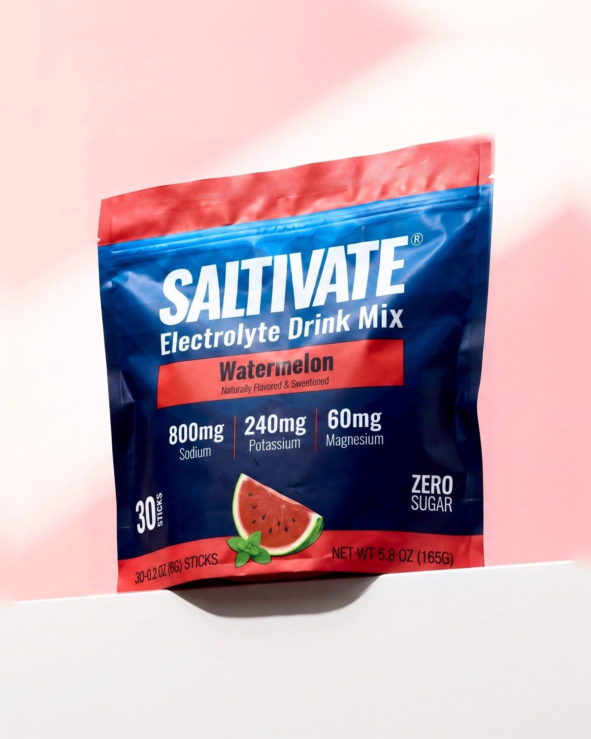 Saltivate Watermelon 30-stick pouch on a white ledge against a pale pink backdrop