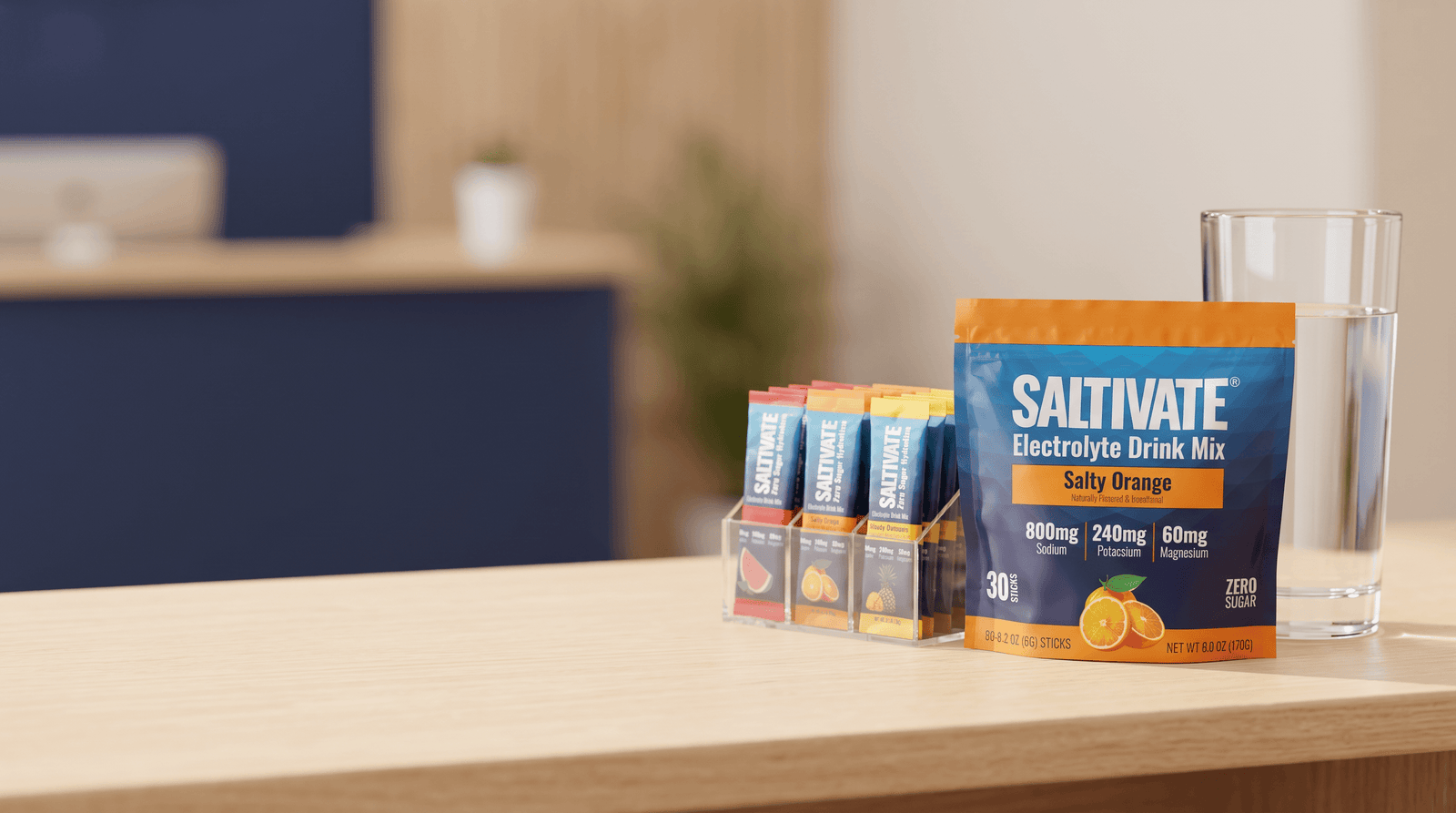 Saltivate Salty Orange 30-count stick pack pouch and a display of stick packets on a front-desk counter